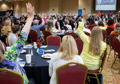 people sitting at tables for an event